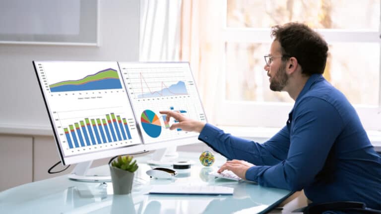 Data analyst inspecting chart on screen